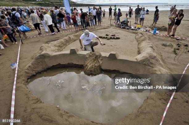 Photo. A Dambusters sandcastle sculpture is near completion on Croyde beach, Devon, where the UK National Sandcastle competition is being held to...