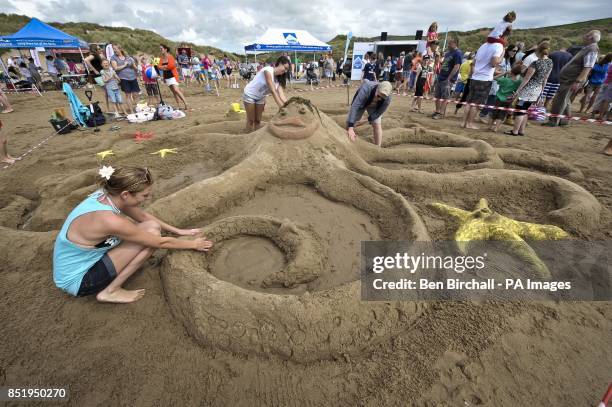 Photo. A giant octopus in the centre of a sea-themed sandcastle sculpture is near completion by the North Devon Hospice team on Croyde beach, Devon,...