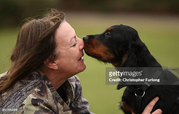 Four-month-old Gordon Setter Lewis and breeder Pauline Quartermaster pose for photographers at The National Exhibition Centre during a photocall to...
