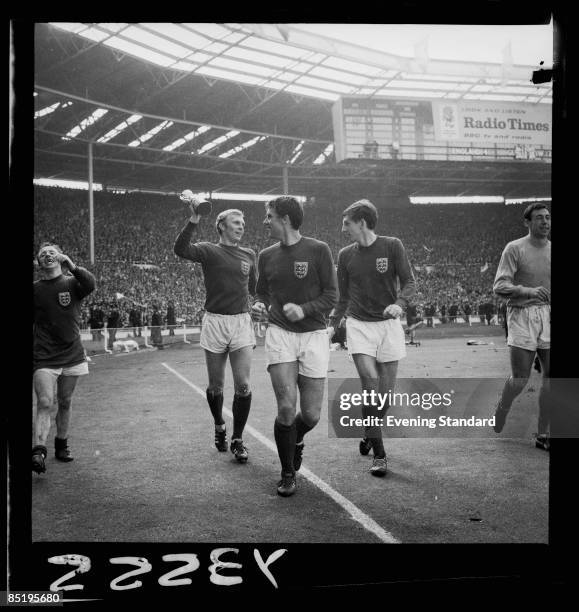 England captain Bobby Moore holds up the Jules Rimet trophy after his team's 4-2 victory over West Germany in the World Cup Final at Wembley Stadium,...