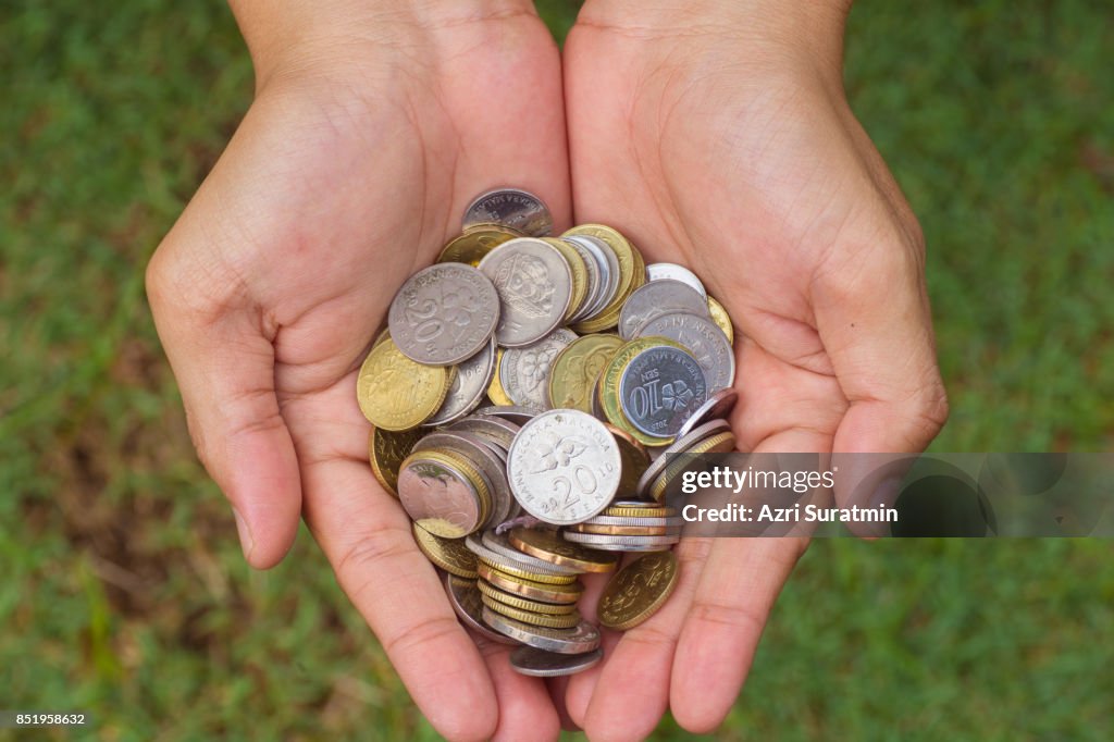 Close up coins in hand