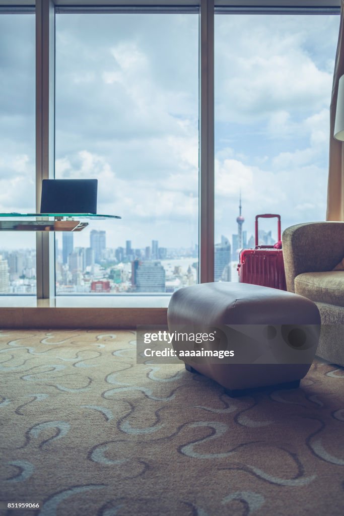 Desk with laptop in front of shanghai city skyline