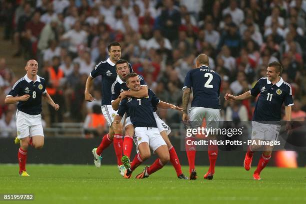 Scotland's James Morrison celebrates with team-mates after scoring his team's opening goal