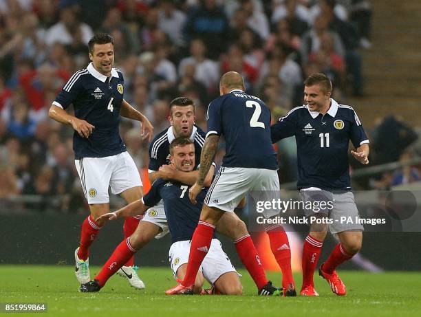 Scotland's James Morrison celebrates with team-mates after scoring his team's opening goal