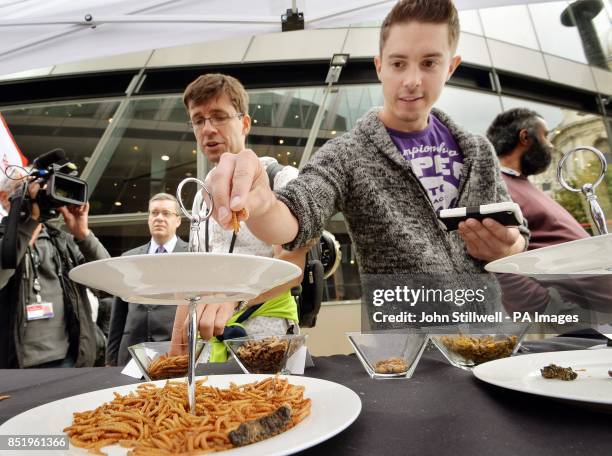 Chris Milford grabs a handful of the mealworm starters, as he prepares to eat his bugs lunch at the Rentokill 'pop-up pestaurant' in the City of...