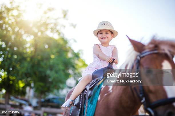 beautiful child on a horse - pony stock pictures, royalty-free photos & images