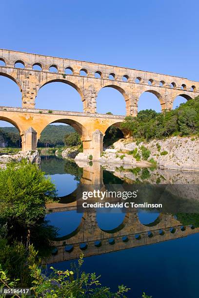 the pont du gard reflected in river, france - pont du gard aqueduct ストックフォトと画像