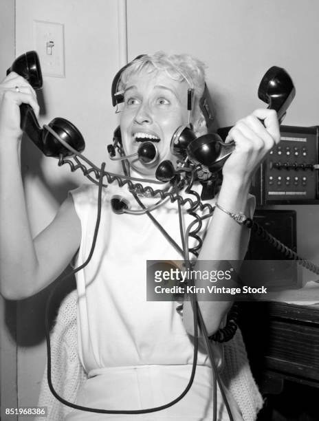 Tangled up in wires, a young switchboard operator appears to panic.