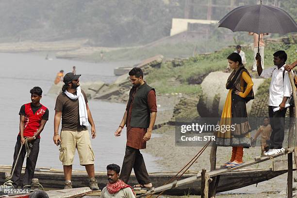 Indian Bollywood actress Aishwarya Rai and actor Abhishek Bachchan prepare to board a boat for filming on the Ganga river at Agarpara, near Kolkata,...