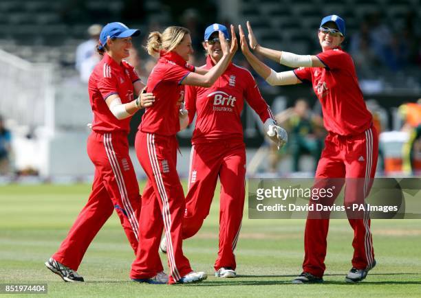 England's Laura Marsh is congratulated by team mates after taking the wicket of Australia's Meg Lanning during the first Ashes One Day International...