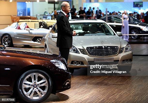 Dieter Zetsche, Chairman of the Board of Management of Daimler AG, stands in between two new E-Class cars and addresses the audience during the first...