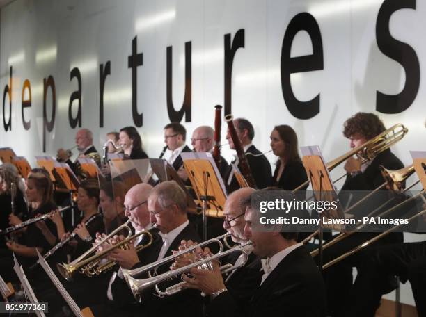 The Royal Scottish National Orchestra plays in the main check-in hall at Glasgow Airport.