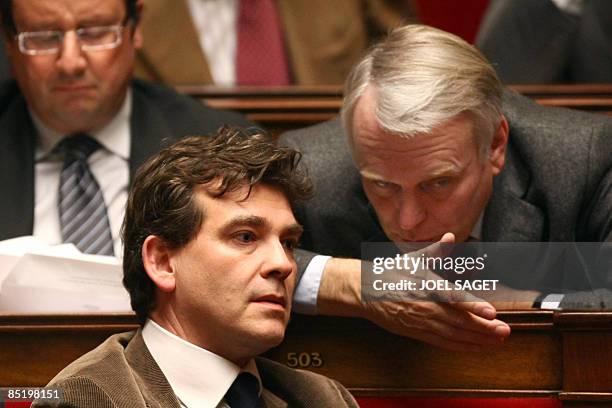 Former French socialist party first secretary Francois Hollande sits next to head of French PS group at the national Assembly Jean-Marc Ayrault...