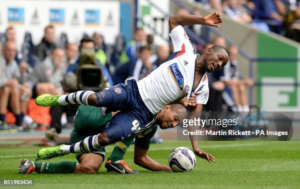 Bolton Wanderers Medo Kamara battles for the ball with Queens Park Rangers Karl Henry during the Sky Bet Football League Championship match at the...