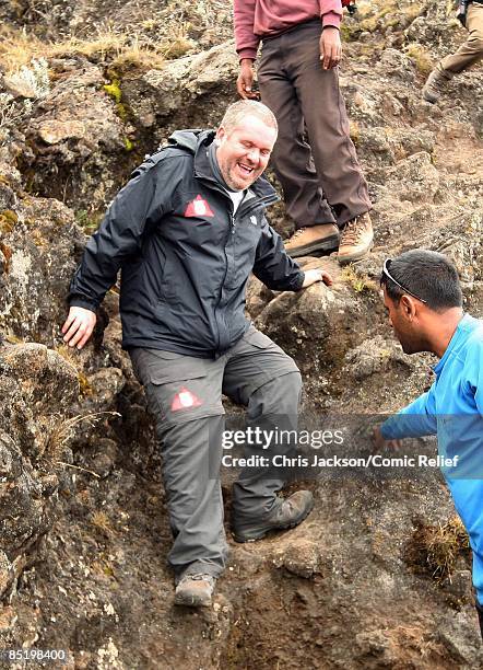 Chris Moyles treks on a steep section of mountain on the second day of The BT Red Nose Climb of Kilimanjaro on March 3, 2009 in Arusha, Tanzania....