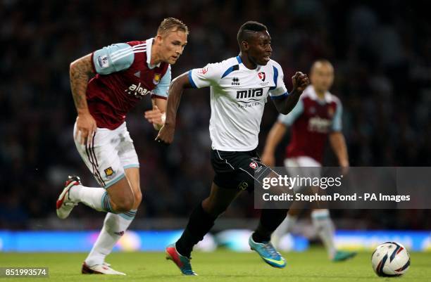 West Ham United's Jack Collison and Cheltenham Town's Jermaine McGlashan compete for the ball during the Capital One Cup, Second Round match at Upton...