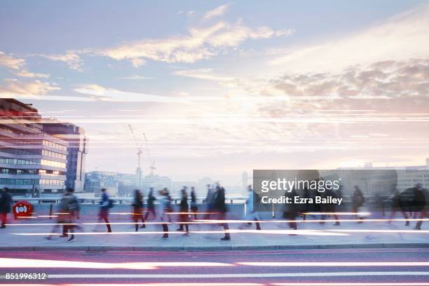 business people walking through the city at dawn. - hauptverkehrszeit stock-fotos und bilder