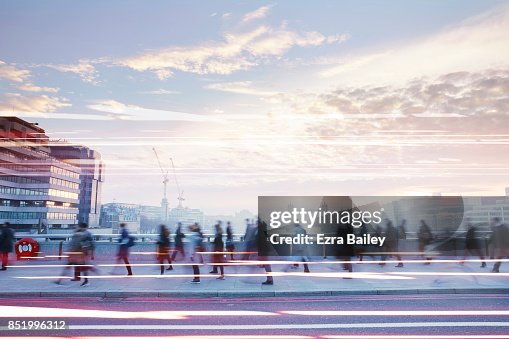 Business people walking through the city at dawn. Business people walking through the city at dawn.