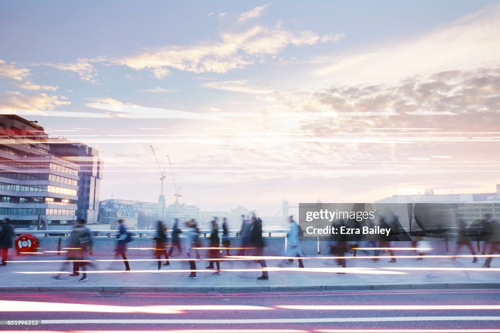 Business people walking through the city at dawn.