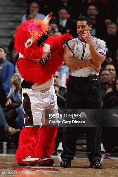 Mascot Benny of the Chicago Bulls interacts with referee Bill Kennedy during the game between the Orlando Magic and the Chicago Bulls at the United...
