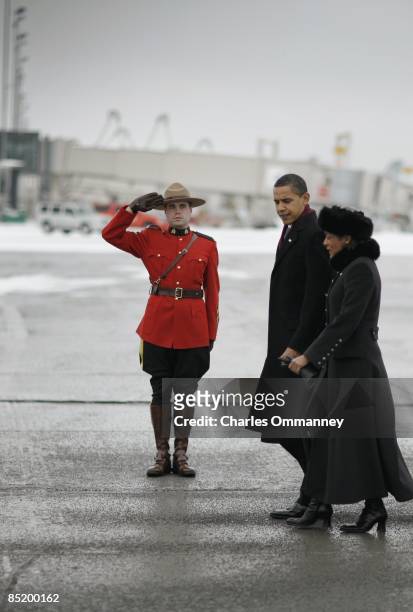 President Barack Obama walks with Governor General of Canada Michaelle Jean upon his arrival at the Ottawa International Airport on February 19, 2009...