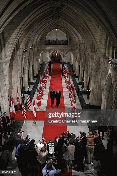 President Barack Obama walks with Canadian Prime Minister Stephen Harper through the Hall of Honor at Parliament Hill on February 19, 2009 in Ottawa,...