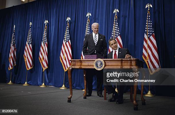 Vice President Joe Biden and US President Barack Obama sign the American Recovery and Reinvestment Act at the Denver Museum of Nature and Science on...