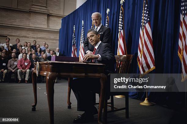 Vice President Joe Biden and US President Barack Obama sign the American Recovery and Reinvestment Act at the Denver Museum of Nature and Science on...