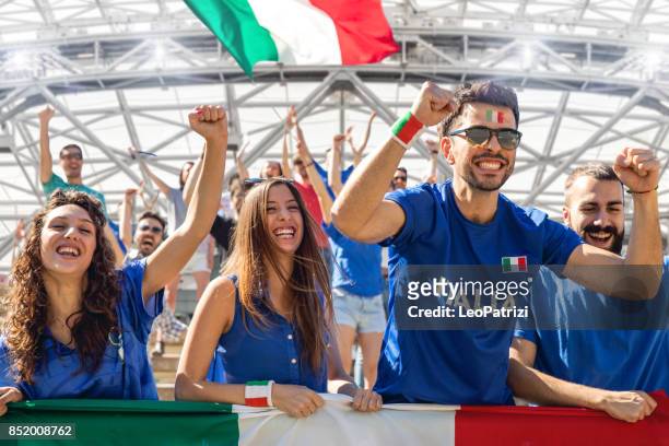 cheering multi-ethnic game supporters - italia stock pictures, royalty-free photos & images