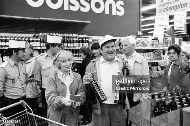 Filming of a series of 'Terry and June', where they go on a day trip to Boulogne, they are pictured in a supermarket, actress June Whitfield plays...