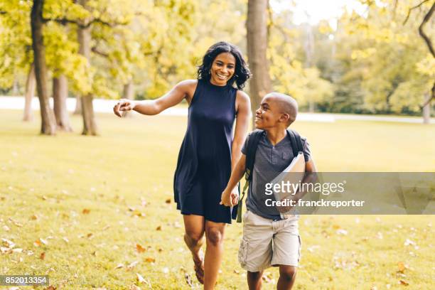 mom walking with his soon before school - first day school hug stock pictures, royalty-free photos & images