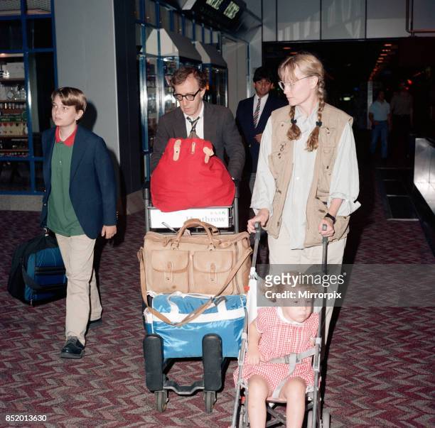 Woody Allen and his partner, actress Mia Farrow, with some of their children at London Heathrow Airport, 8th August 1988, .
