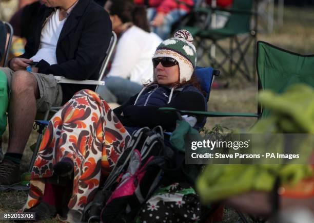 One fan wraps up warm as she waits for The Feeling to perform at the Big Feastival which has been organised by Alex James and Jamie Oliver at Alex...