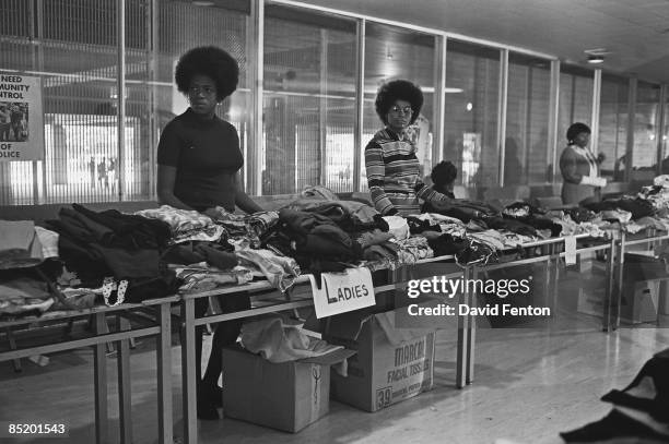 Members of the Black Panther Party stand behind tables ready to distribute free clothing to the public, New Haven, Connecticut, September 28, 1969.