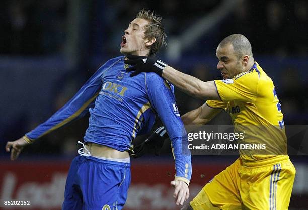 Chelsea's Brazilian player Alex challenges Portsmouth's Peter Crouch during the Premiership football match at Fratton Park in Portsmouth on March 3,...