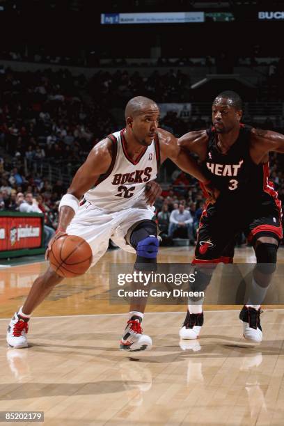 Michael Redd of the Milwaukee Bucks drives to the basket past Dwyane Wade of the Miami Heat during the game on January 14, 2009 at the Bradley Center...