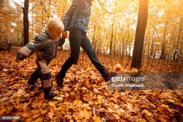 mother and child in the park - russia rain boots imagens e fotografias de stock