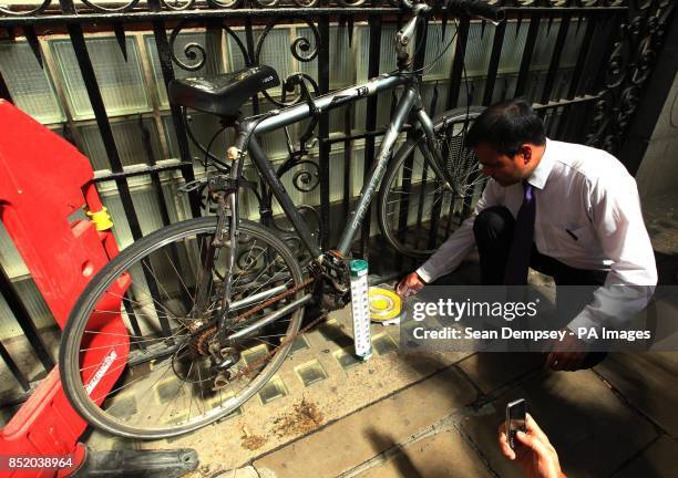 Saddle of bicycle appears melted as sun reflects off 20 Fenchurch Street, known as the Walkie Talkie, onto Eastcheap Street in the City of London.