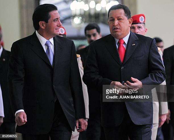 Venezuelan President Hugo Chavez talks to his Panamanian counterpart Martin Torrijos upon arrival at the Miraflores presidential palace in Caracas on...
