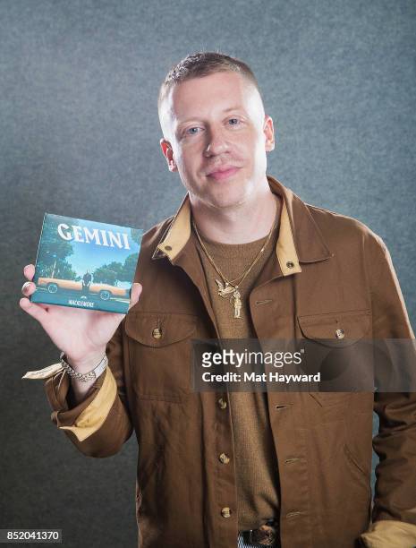 Ben Haggerty aka Macklemore poses for a portrait with a copy his new album "Gemini" at Hot 103.7 on September 22, 2017 in Seattle, Washington.