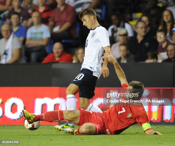 England's Tom Carroll is tackled by Moldova's Eugen Zasaviitchi during the UEFA Euro Under 21's Qualifying match at The Madejski Stadium, Reading.