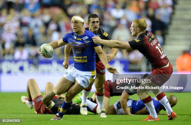 Leeds Rhinos Carl Ablett is tackled by Wigan Warriors Liam Farrell, during the Super League match at the DW Stadium, Wigan.