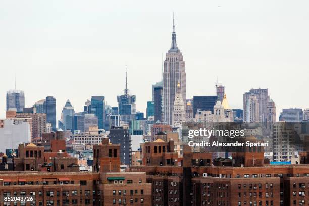 manhattan skyline with lower east side on foreground and empire state building in the background - deco district stock pictures, royalty-free photos & images