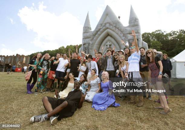 Festival goers Charlotte Rice and Calum Lyon , both aged 20 from the Isle of Wight celebrate their 'marriage' by Sule Rimi from Cardiff, outside the...