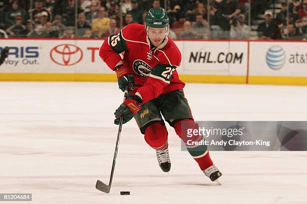 Eric Belanger of the Minnesota Wild skates with the puck against the Los Angeles Kings during the game at the Xcel Energy Center on February 24, 2009...