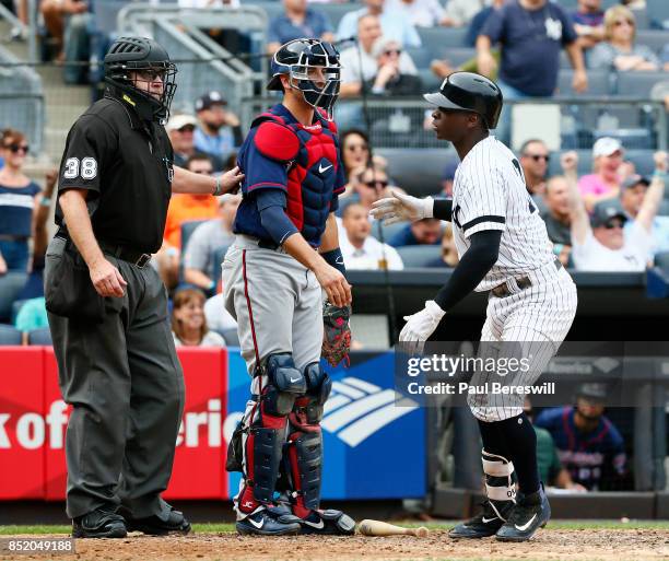 Didi Gregorius of the New York Yankees hits his 25th home run of the season and lets go of his bat on the follow through which hit catcher Jason...