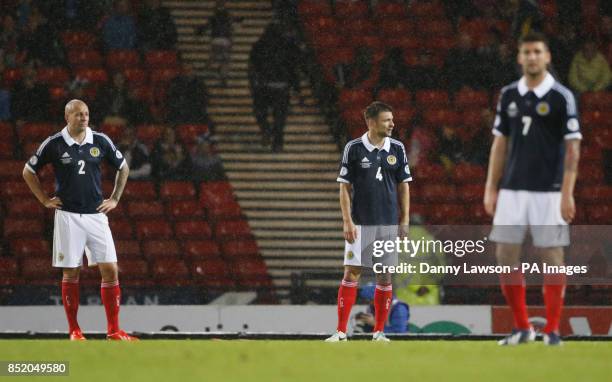 Scotland's Alan Hutton , Russell Martin and Charlie Mulgrew stand dejected following Belgium's Kevin Mirallas goal during the World Cup Qualifying,...
