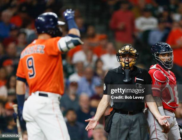 Home plate umpire Dan Iassongna gestures to Marwin Gonzalez of the Houston Astros who was arguing balls and strikes in the seventh inning against the...