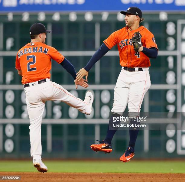 Alex Bregman of the Houston Astros and George Springer celebrate a 3-0 win over the Los Angeles Angels of Anaheim at Minute Maid Park on September...