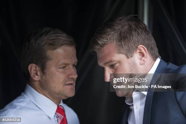 Swindon Town manager Mark Cooper and MK Dons manager Karl Robinson during the Sky Bet Football League One match at Stadium:MK, Milton Keynes.